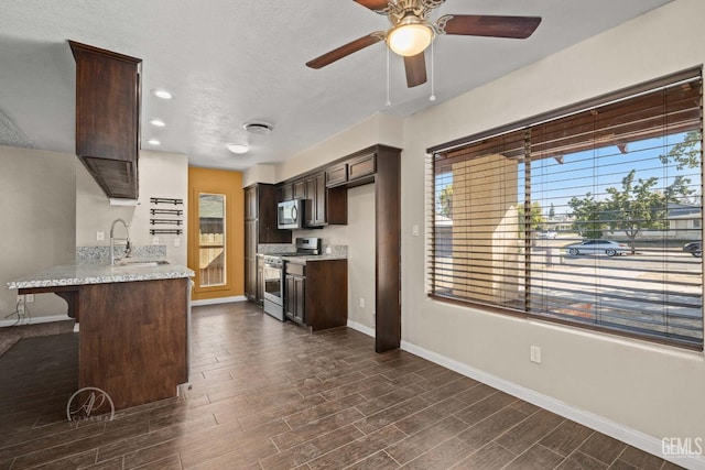 kitchen with sink, a breakfast bar area, stainless steel appliances, dark hardwood / wood-style floors, and dark brown cabinetry