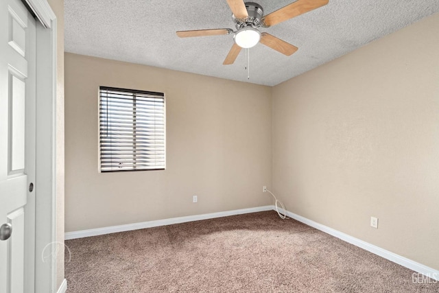 carpeted empty room with ceiling fan and a textured ceiling