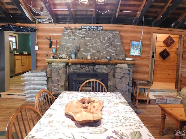 9525 Shirley Meadows Rd Unit 6, Wofford Heights, CA 93285 - dining room featuring rustic walls, wood finished floors, a fireplace, and beam ceiling