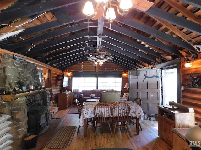 9525 Shirley Meadows Rd Unit 6, Wofford Heights, CA 93285 - dining area featuring a wood stove, hardwood / wood-style flooring, vaulted ceiling, and wood walls