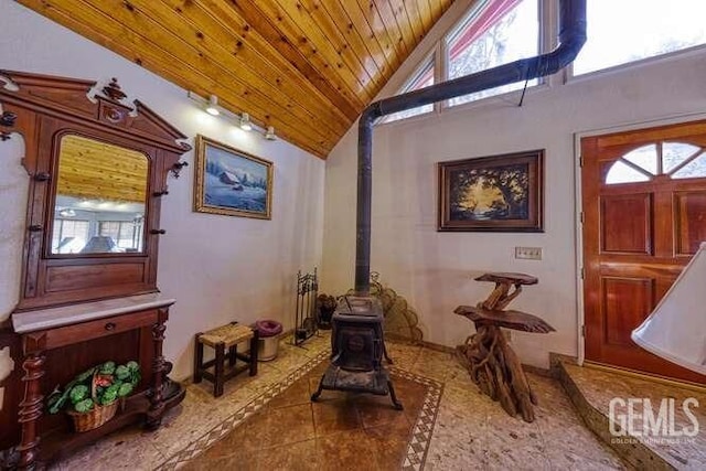 living area featuring high vaulted ceiling, wood ceiling, a wood stove, and tile patterned flooring