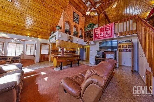 living area featuring stairway, high vaulted ceiling, wood ceiling, and ceiling fan