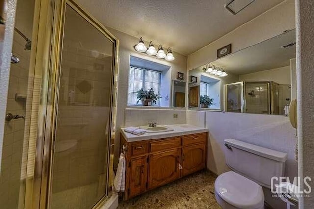 bathroom with vanity, visible vents, a stall shower, a textured ceiling, and toilet