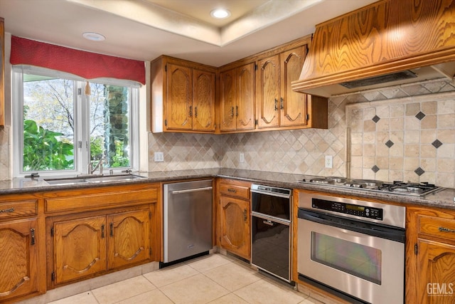 7858 Stine Rd, Bakersfield, CA 93313 - kitchen with custom exhaust hood, brown cabinets, a sink, and appliances with stainless steel finishes