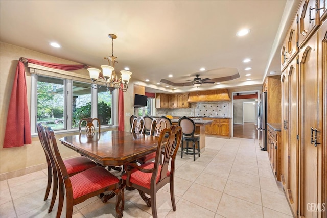 7858 Stine Rd, Bakersfield, CA 93313 - dining room featuring ceiling fan with notable chandelier, a tray ceiling, recessed lighting, light tile patterned flooring, and baseboards