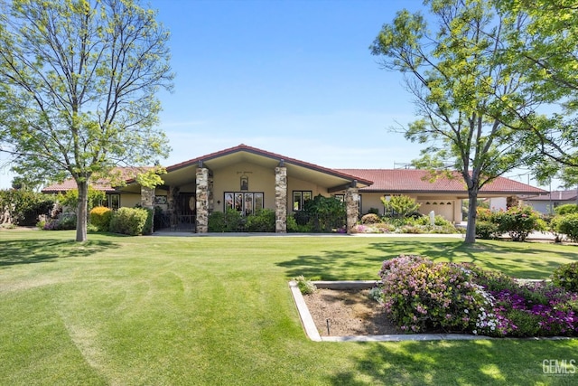7858 Stine Rd, Bakersfield, CA 93313 - view of front of property with an attached garage, stucco siding, a front lawn, and a tile roof