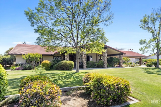 7858 Stine Rd, Bakersfield, CA 93313 - single story home with stucco siding, a front lawn, and a tile roof