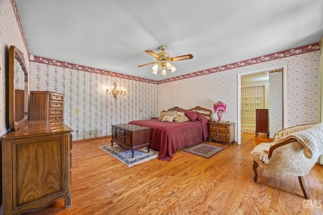 7858 Stine Rd, Bakersfield, CA 93313 - bedroom featuring light wood-type flooring, wallpapered walls, and ceiling fan with notable chandelier
