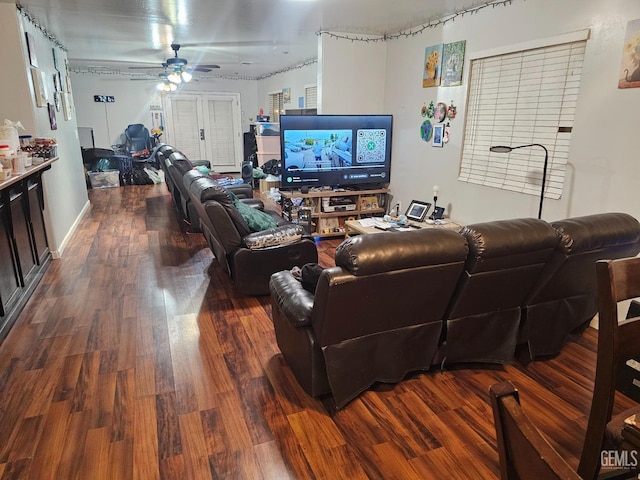 living room with ceiling fan and dark hardwood / wood-style flooring