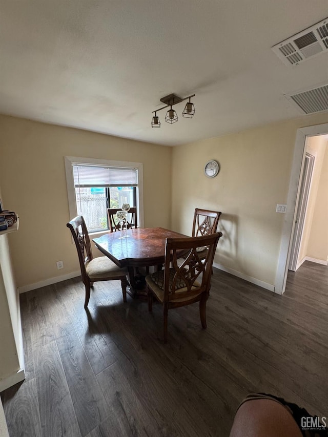 dining space featuring visible vents, baseboards, and dark wood-type flooring