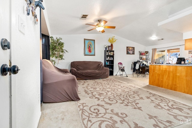 living area featuring lofted ceiling, carpet flooring, and visible vents