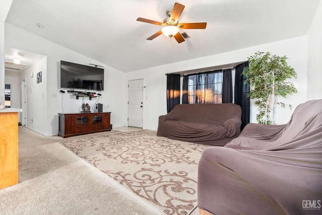 carpeted living room featuring visible vents, a ceiling fan, and vaulted ceiling