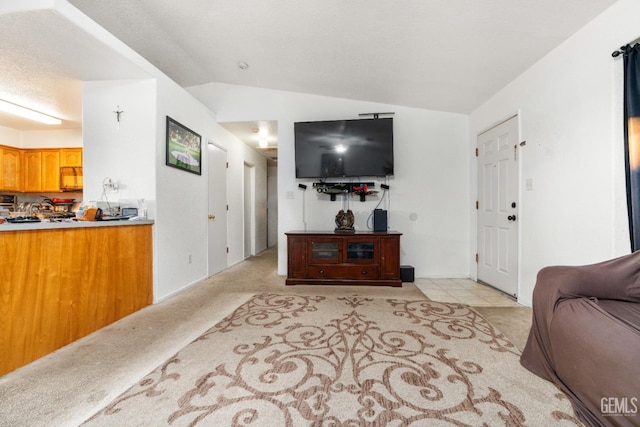 living area with light carpet and lofted ceiling