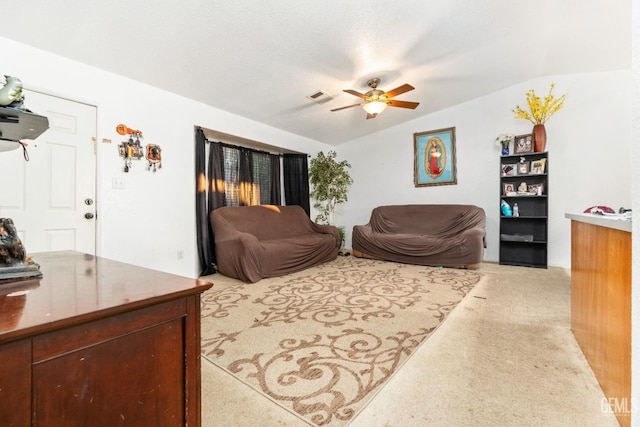 living room featuring visible vents, carpet, ceiling fan, and vaulted ceiling