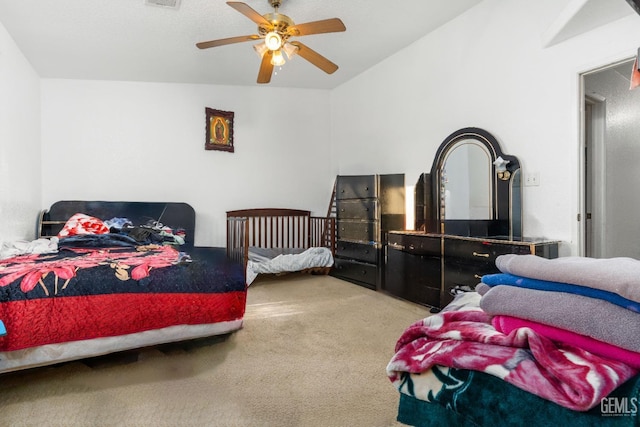 bedroom with carpet flooring, a ceiling fan, and visible vents