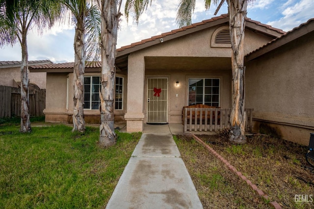 view of front of property with stucco siding and a front lawn