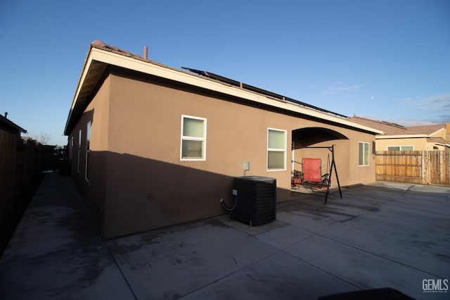 rear view of house with cooling unit and a patio area