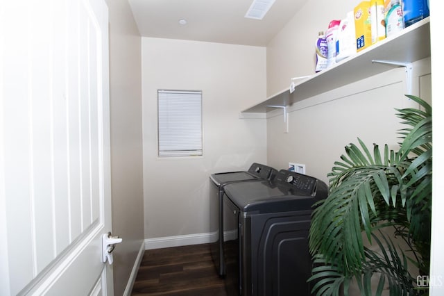 laundry area featuring washing machine and dryer and dark hardwood / wood-style flooring