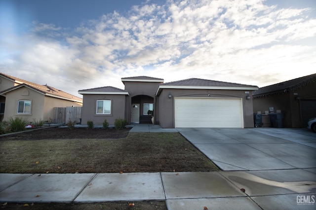 view of front of house featuring a front yard and a garage