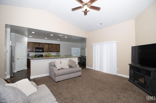 living room featuring dark carpet, ceiling fan, and lofted ceiling