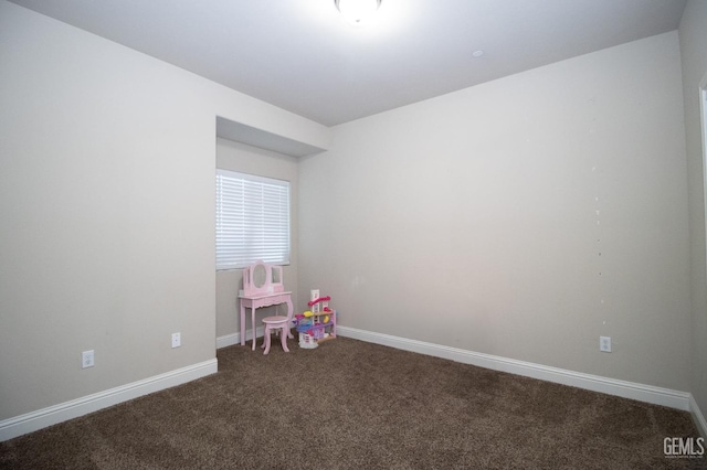 recreation room featuring dark colored carpet