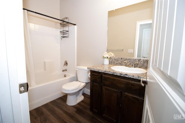 full bathroom with toilet, vanity, hardwood / wood-style flooring, and bathing tub / shower combination