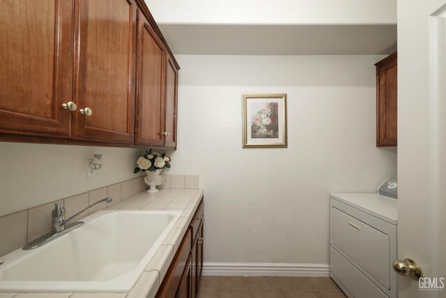 12504 Crown Crest Dr, Bakersfield, CA 93311 - laundry area featuring washer / clothes dryer, cabinet space, and light tile patterned floors
