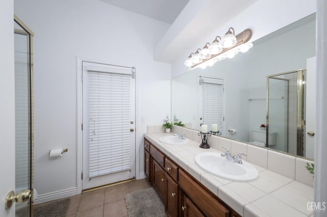 12504 Crown Crest Dr, Bakersfield, CA 93311 - bathroom featuring double vanity, tile patterned flooring, and a shower with door