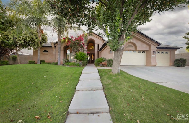 12504 Crown Crest Dr, Bakersfield, CA 93311 - mediterranean / spanish-style home with an attached garage, stucco siding, a front yard, concrete driveway, and a tile roof