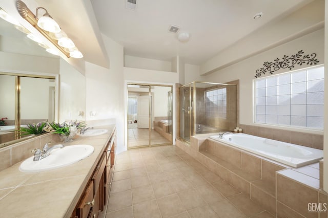 12504 Crown Crest Dr, Bakersfield, CA 93311 - full bath featuring double vanity, a bath, tile patterned flooring, and a stall shower