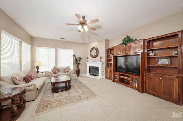 12504 Crown Crest Dr, Bakersfield, CA 93311 - living room with a ceiling fan, a glass covered fireplace, and light colored carpet