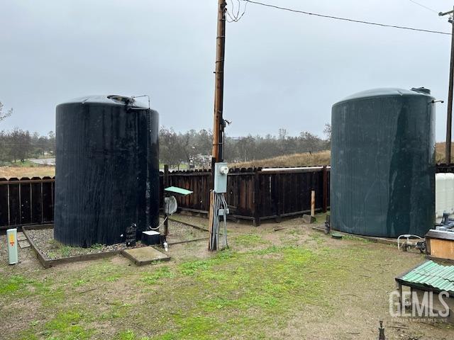 view of yard featuring an outbuilding, a storage unit, and a fenced backyard