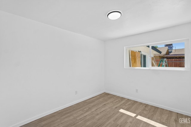 spare room featuring wood-type flooring