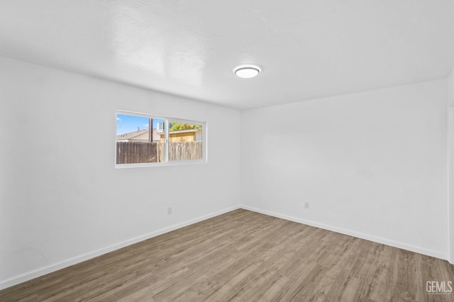 empty room with hardwood / wood-style flooring