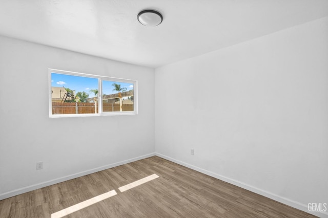 empty room with wood-type flooring