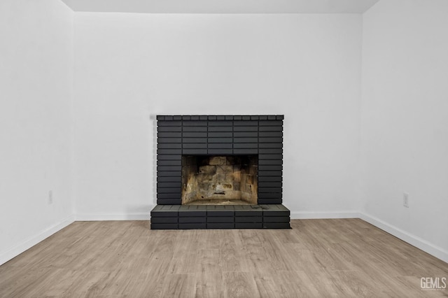 interior details with a fireplace and hardwood / wood-style floors