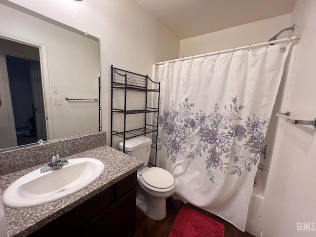 full bathroom featuring hardwood / wood-style floors, vanity, toilet, and shower / tub combo with curtain