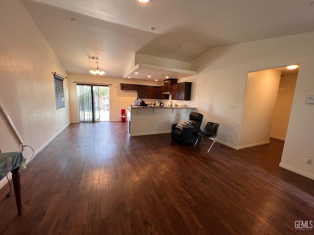 unfurnished living room featuring an inviting chandelier, dark hardwood / wood-style floors, and vaulted ceiling