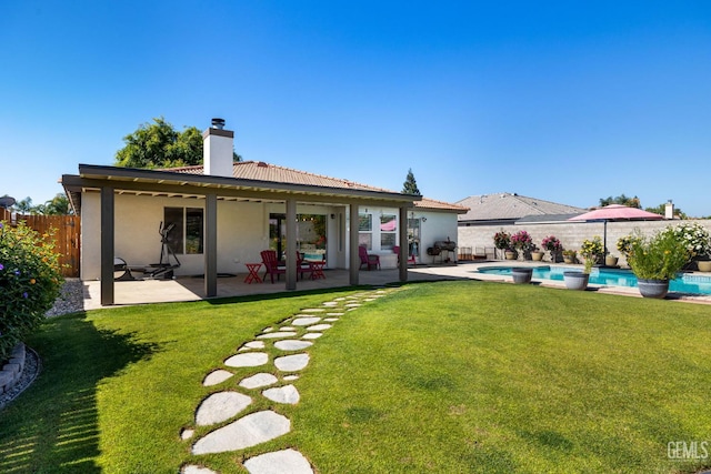 5512 Sicily Ct, Bakersfield, CA 93308 - back of property featuring a chimney, a patio, and stucco siding