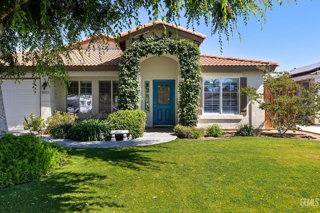 5512 Sicily Ct, Bakersfield, CA 93308 - mediterranean / spanish-style home with a front lawn, a garage, a tile roof, and stucco siding