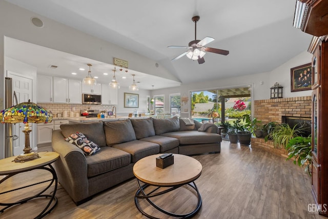 5512 Sicily Ct, Bakersfield, CA 93308 - living room with lofted ceiling, a ceiling fan, wood finished floors, and a fireplace