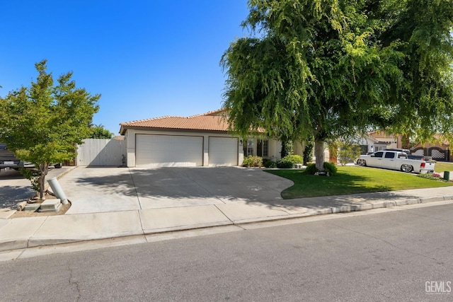 5512 Sicily Ct, Bakersfield, CA 93308 - view of property hidden behind natural elements featuring an attached garage, driveway, a tiled roof, and stucco siding