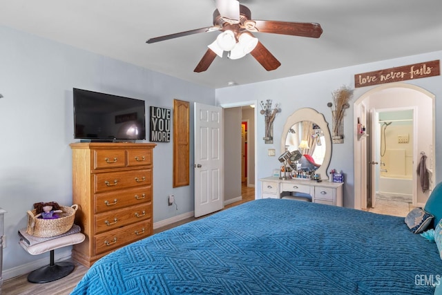 5512 Sicily Ct, Bakersfield, CA 93308 - bedroom with arched walkways, ceiling fan, baseboards, and connected bathroom