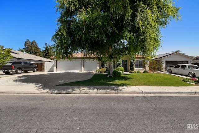 5512 Sicily Ct, Bakersfield, CA 93308 - obstructed view of property with concrete driveway, a garage, a front lawn, and roof mounted solar panels
