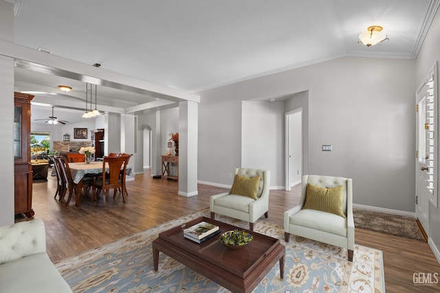 5512 Sicily Ct, Bakersfield, CA 93308 - living room with wood finished floors, ceiling fan, ornamental molding, arched walkways, and baseboards