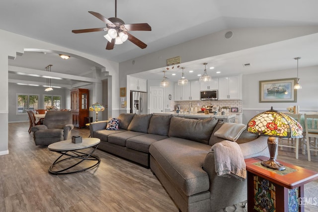 5512 Sicily Ct, Bakersfield, CA 93308 - living area with wood finished floors, a ceiling fan, arched walkways, and vaulted ceiling