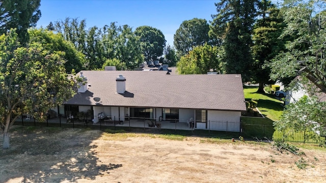 5600 Kirkside Dr Unit F, Bakersfield, CA 93311 - view of front of property with view of wooded area, a shingled roof, and a chimney