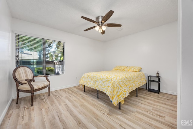 5600 Kirkside Dr Unit F, Bakersfield, CA 93311 - bedroom with light wood finished floors, baseboards, a ceiling fan, and a textured ceiling