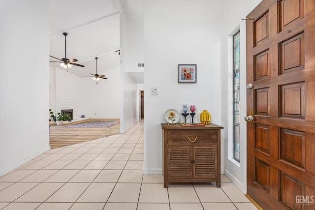 5600 Kirkside Dr Unit F, Bakersfield, CA 93311 - entrance foyer with light tile patterned floors, ceiling fan, a brick fireplace, high vaulted ceiling, and baseboards