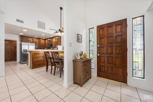 5600 Kirkside Dr Unit F, Bakersfield, CA 93311 - entrance foyer with plenty of natural light, a ceiling fan, light tile patterned flooring, baseboards, and a high ceiling